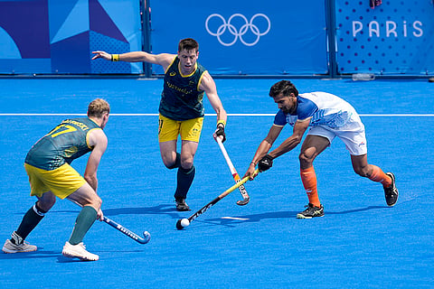 Abhishek Abhishek, right, battles for the ball with Australian players